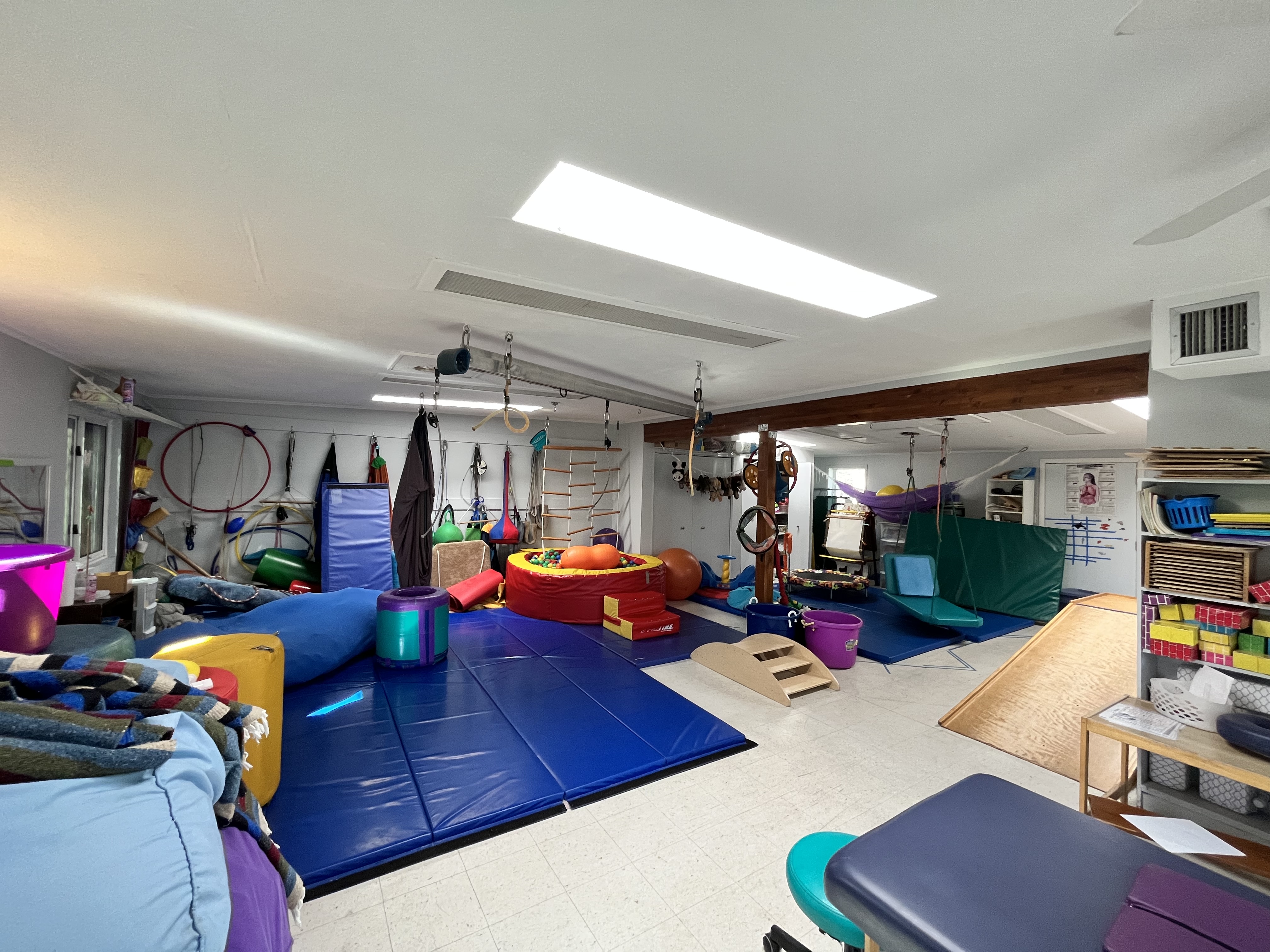 Image of a playroom showing a brightly colored space with toys and furniture